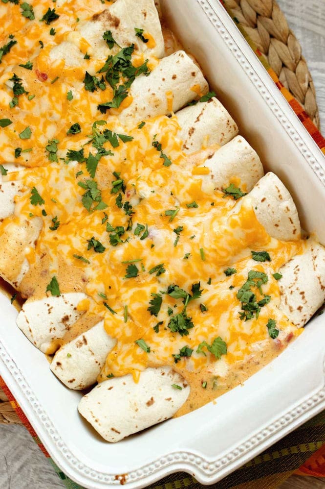 Cheesy Cajun Shrimp Enchiladas - Shrimp smothered in a homemade cheese sauce with Creole spices rolled into flour tortillas and baked. 