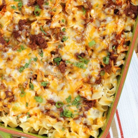 Mexican Noodle Bake - An easy layered casserole filled with seasoned ground beef, a Mexican flavored sauce, cheesy noodles, and topped with shredded cheese.  You will not be slaving away on this delicious meal, I promise!