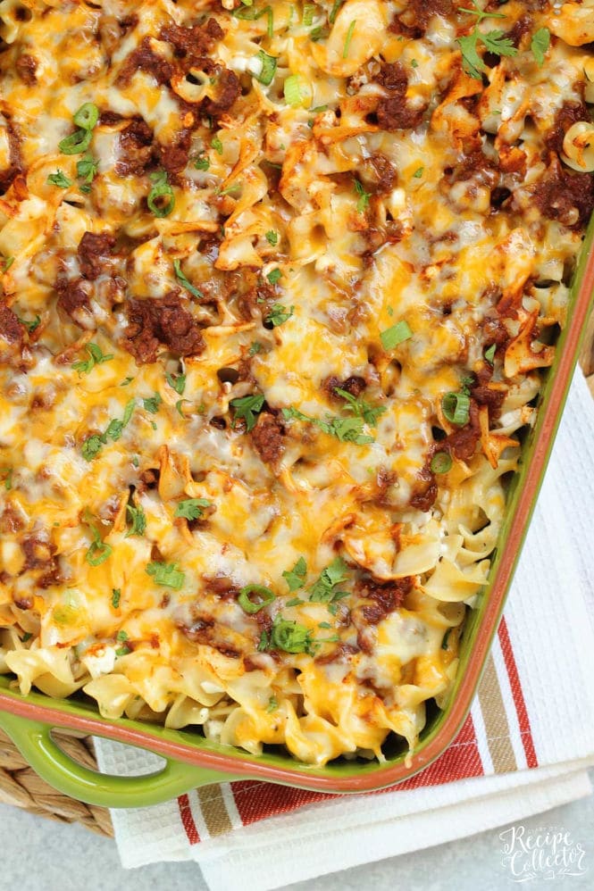 Mexican Noodle Bake - An easy layered casserole filled with seasoned ground beef, a Mexican flavored sauce, cheesy noodles, and topped with shredded cheese.  You will not be slaving away on this delicious meal, I promise!