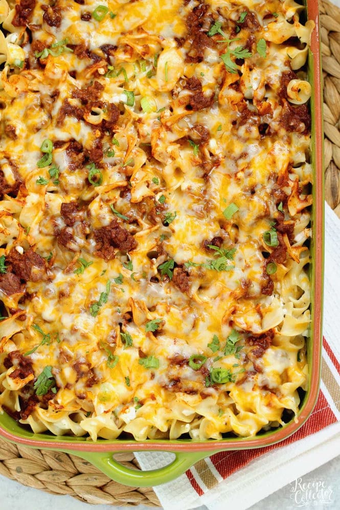 Mexican Noodle Bake - An easy layered casserole filled with seasoned ground beef, a Mexican flavored sauce, cheesy noodles, and topped with shredded cheese.  You will not be slaving away on this delicious meal, I promise!