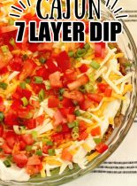 Cajun 7 Layer Dip - Layers of refried beans, black-eyed peas, guacamole, cajun sour cream, and Tony Chachere's Creole Seasoning topped with red bell peppers, tomatoes, green onions, and shredded cheese.