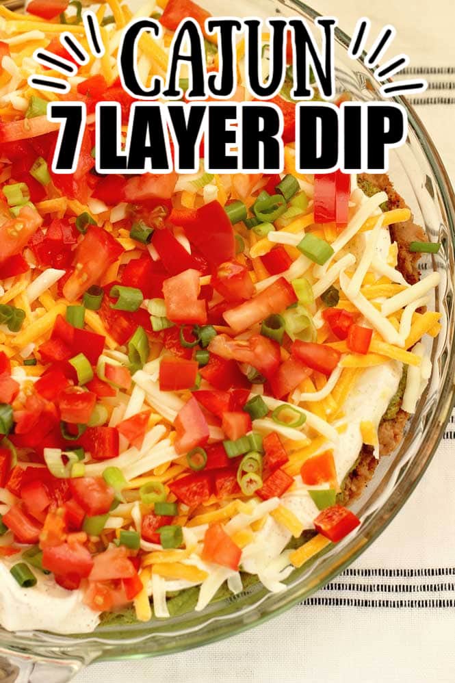 Cajun 7 Layer Dip - Layers of refried beans, black-eyed peas, guacamole, cajun sour cream, and Tony Chachere's Creole Seasoning topped with red bell peppers, tomatoes, green onions, and shredded cheese.