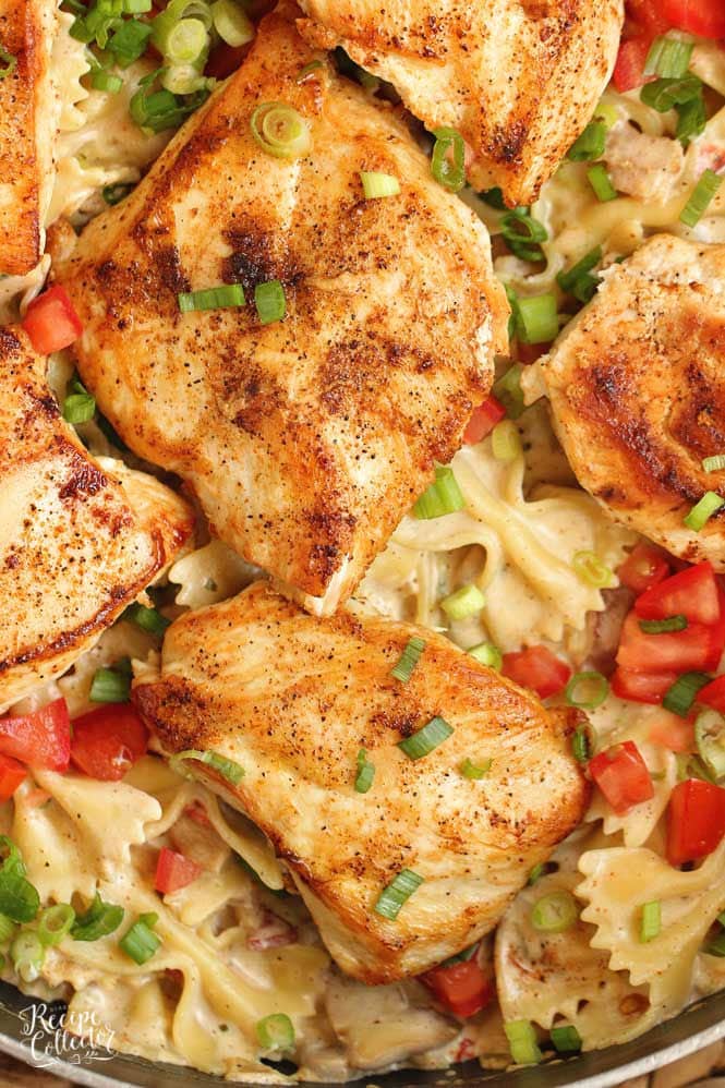 Roasted Garlic Cajun Chicken Pasta - Creole seasoned chicken breasts over bow tie pasta tossed with a delicious roasted garlic cream sauce. 