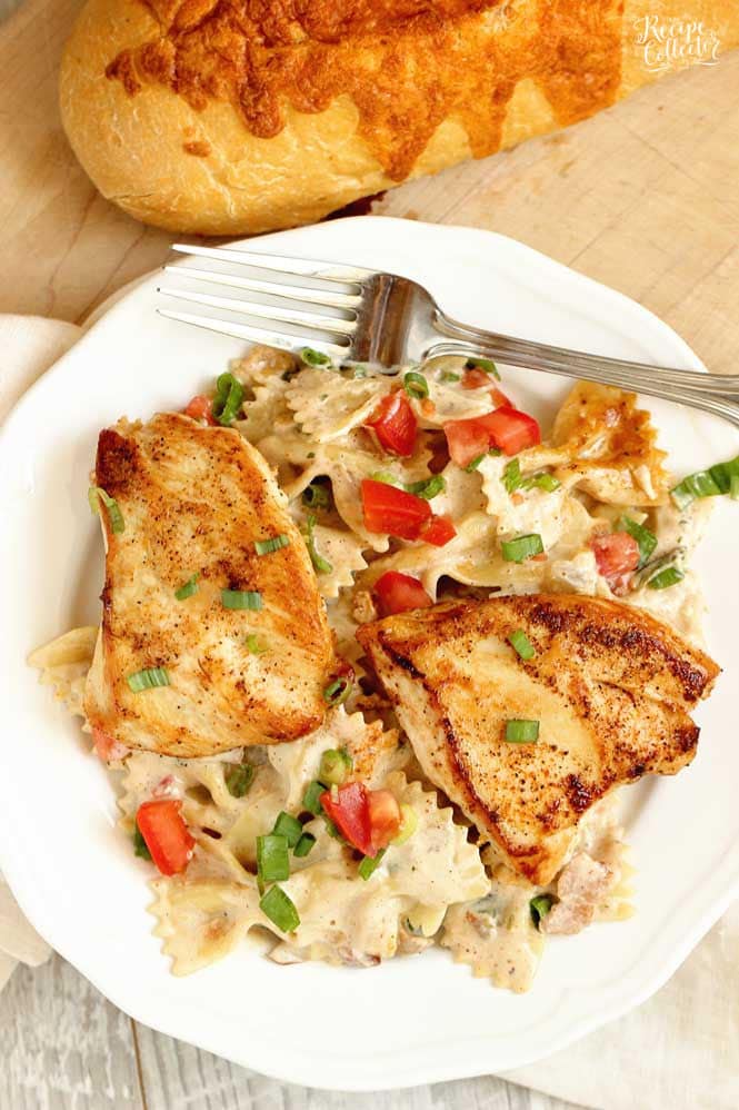 Roasted Garlic Cajun Chicken Pasta - Creole seasoned chicken breasts over bow tie pasta tossed with a delicious roasted garlic cream sauce. 