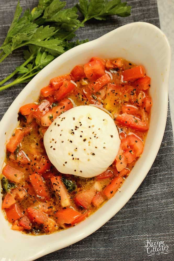 Easy Burrata and Tomatoes - Slightly warmed burrata, basil, olive oil, and diced tomatoes come together for a perfect appetizer or salad. 