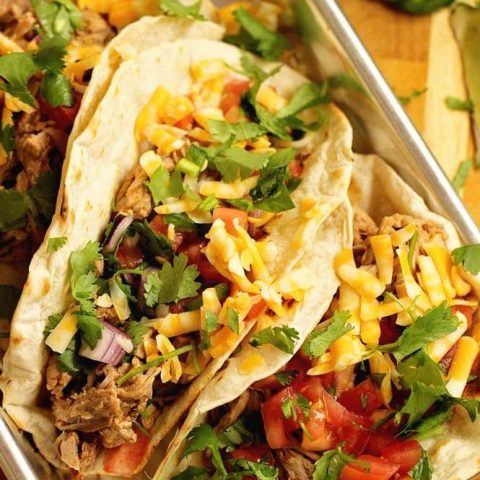 Slow Cooker Pork Tenderloin Tacos - An easy slow cooker dinner idea that is healthy and delicious!  Plus you can serve it with any sort of tacos or make a lettuce wrap with it!