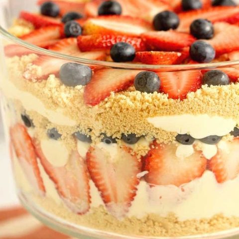 Patriotic Dirt Pudding - An easy and absolutely delicious dessert perfect all summer long. It's layers of cream cheese and vanilla pudding with Golden Oreos, strawberries, and blueberries!