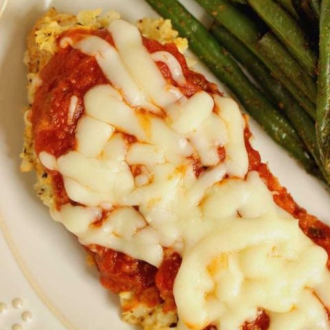 Skinny Cauliflower-Crusted Chicken -An easy low-carb chicken parmesan recipe. It goes great with a green veggie or green salad. It's perfect for meeting those protein and calorie goals!