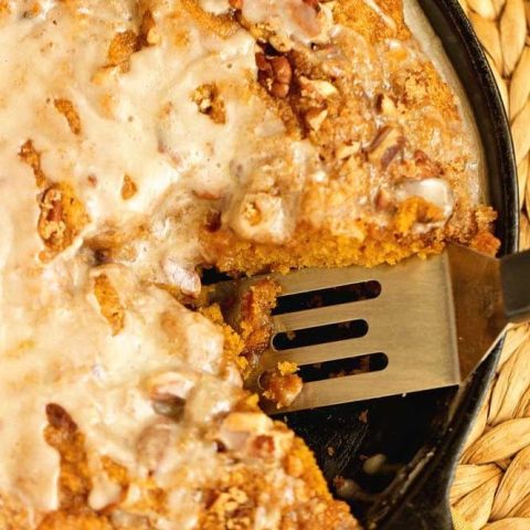 Easy Pumpkin Skillet Coffee Cake - An easy pumpkin recipe perfect for fall. It comes together in one bowl and then it's topped with a sugared pecan topping and an easy glaze.