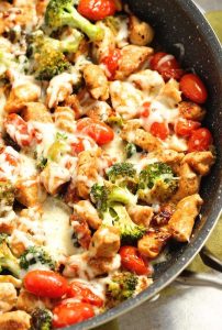 Low-Carb Tuscan Chicken - An easy low-carb healthy one pan dish filled with chicken breasts, broccoli, grape tomatoes, sun-dried tomatoes, spices, and a creamy light sauce and topped with cheese. It's great for meal prep too!
