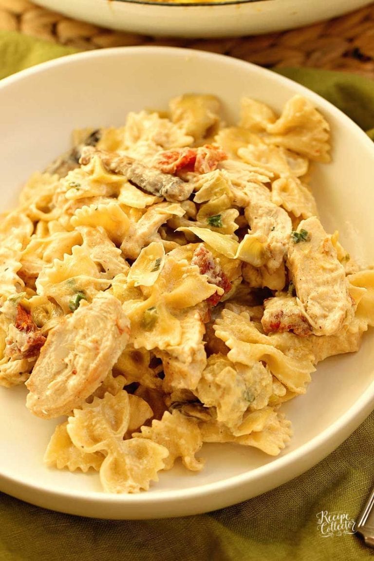 Copycat Spicy Romano Chicken Pasta - Make this creamy restaurant-style chicken pasta made with bow-tie noodles, sun-dried tomatoes, artichoke hearts, mushrooms, and grilled chicken tossed in a creamy dreamy sauce.
