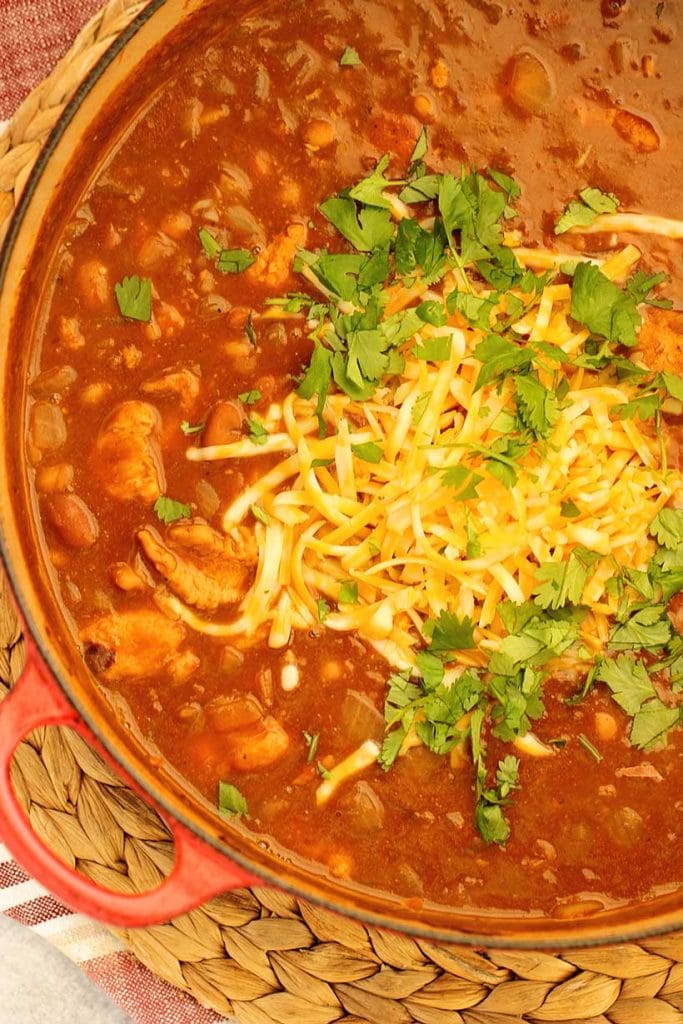 Creamy chicken soup with beans and melty cheese made in one pot. This hearty, high fiber easy soup recipe is ready in 30 minutes and perfect for busy nights.