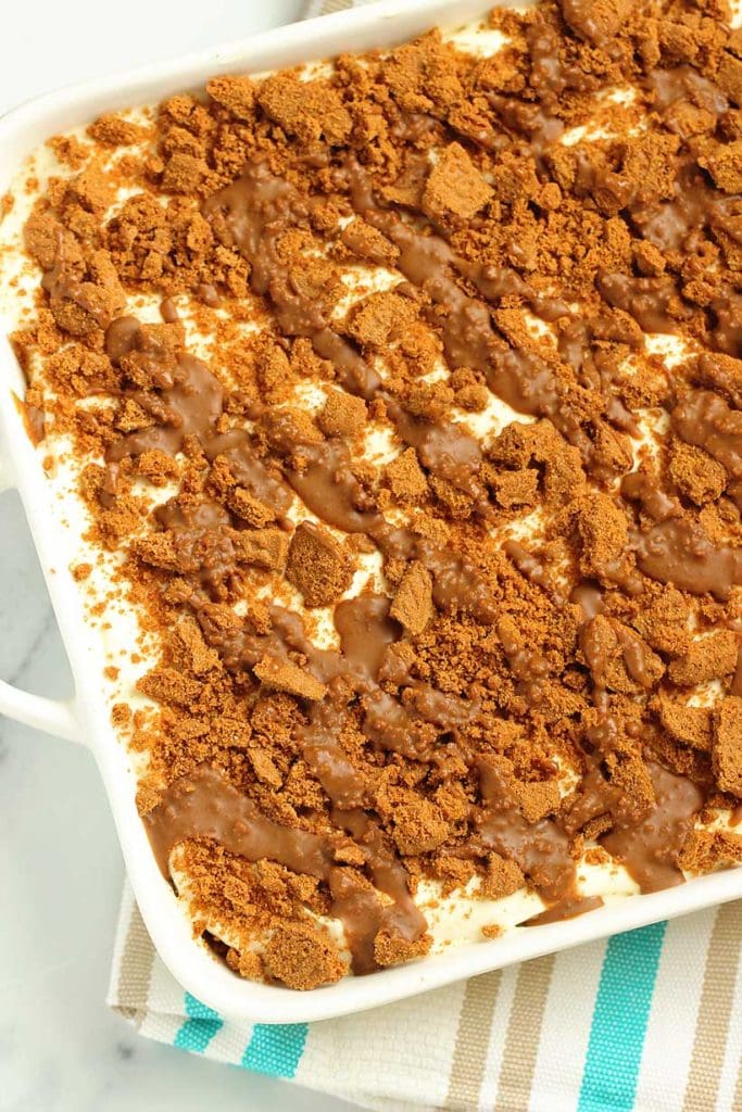 This Easy Biscoff Layer Dessert is the ultimate no-bake treat with layers of Biscoff cookies, dreamy cookie butter, and vanilla cream cheese pudding.  It comes together in one irresistible dish. Perfect for make-ahead gatherings!